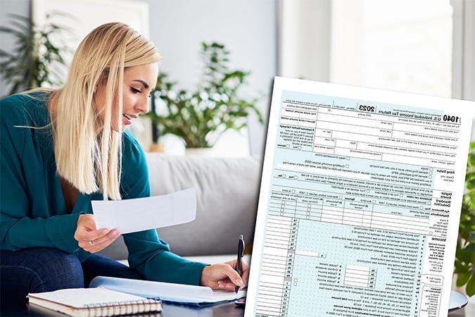 An IRS form 1040 in the foreground while a person fills out a form on a table.